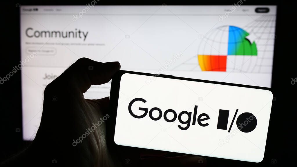 Stuttgart, Germany - 03-19-2024: Person holding mobile phone with logo of annual developer conference Google IO in front of company web page. Focus on phone display.