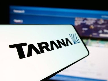 Stuttgart, Germany - 03-28-2024: Cellphone with logo of American telecommunications company Tarana Wireless Inc. in front of website. Focus on center-left of phone display. clipart