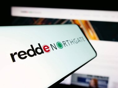 Stuttgart, Germany - 04-07-2024: Smartphone with logo of British vehicle rental company Redde Northgate plc in front of business website. Focus on center-left of phone display. clipart