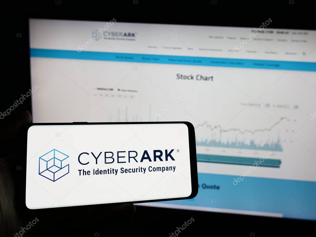 Stuttgart, Germany - 04-13-2024: Person holding mobile phone with logo of American identity security company CyberArk Software Inc. in front of web page. Focus on phone display.