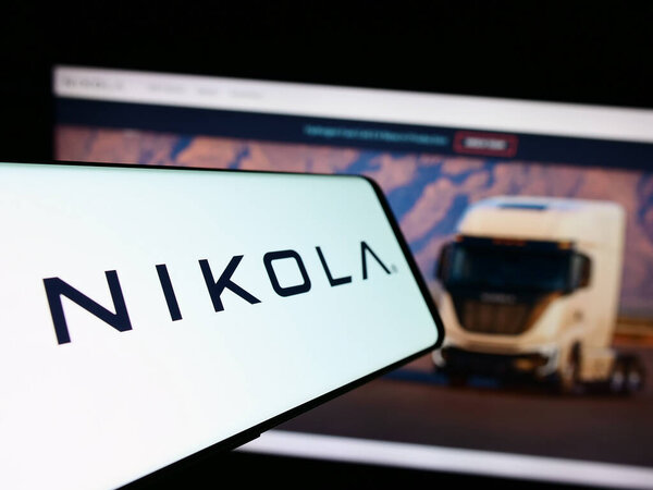 Stuttgart, Germany - 11-17-2023: Mobile phone with logo of American electric vehicle company Nikola Corporation in front of business website. Focus on center of phone display.