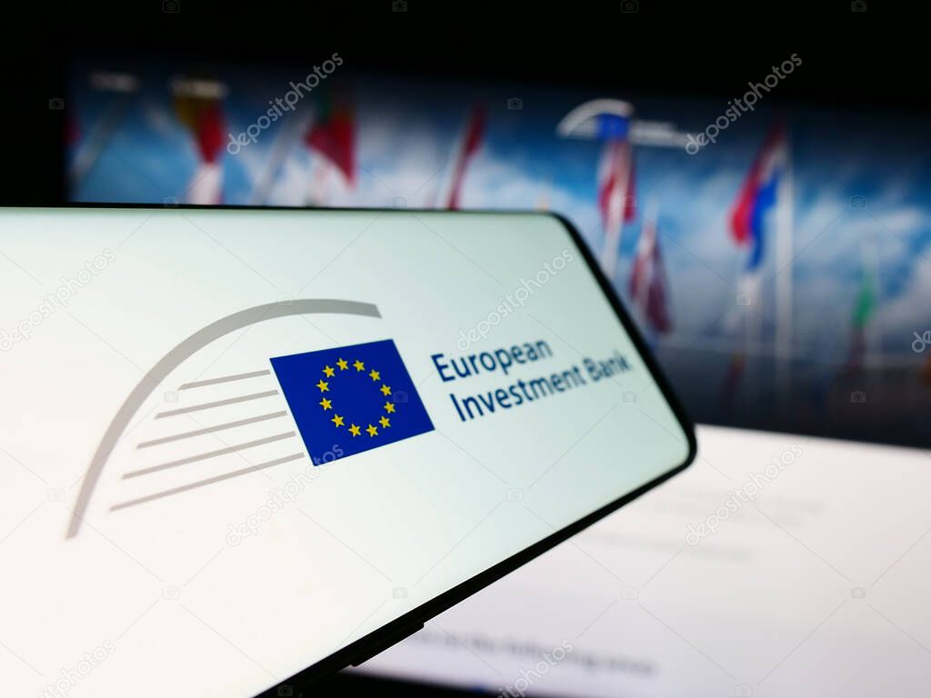Stuttgart, Germany - 11-22-2023: Mobile phone with logo of EU financial institution European Investment Bank (EIB) in front of website. Focus on center-left of phone display.