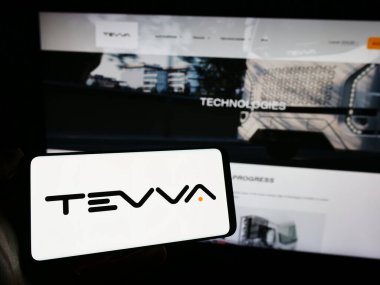 Stuttgart, Almanya - 11-22-2023: İngiliz elektrikli kamyon şirketi Tevva Motors Limited 'in logosunu taşıyan cep telefonu sahibi şirket web sitesi önünde bulunuyor. Telefon ekranına odaklan.
