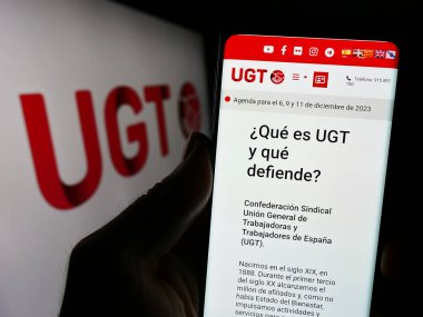 Stuttgart, Almanya - 12-07-2023: Logo önünde İspanyol General de Trabajadores 'in (UGT) web sayfası bulunan kişi. Telefon ekranının merkezine odaklan.