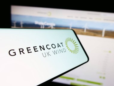 Stuttgart, Germany - 12-12-2023: Mobile phone with logo of British investment company Greencoat UK Wind plc in front of business website. Focus on center of phone display. clipart