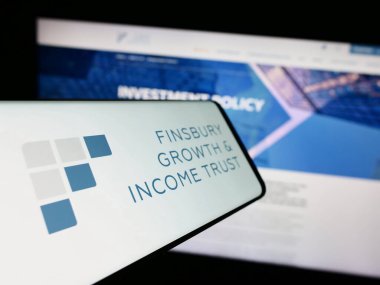 Stuttgart, Germany - 12-12-2023: Smartphone with logo of British company Finsbury Growth Income Trust plc (FGT) in front of website. Focus on center-left of phone display. clipart