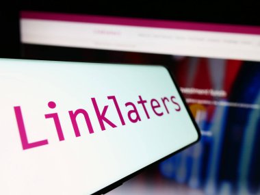 Stuttgart, Germany - 12-17-2023: Smartphone with logo of British law firm Linklaters LLP in front of business website. Focus on center-left of phone display. clipart