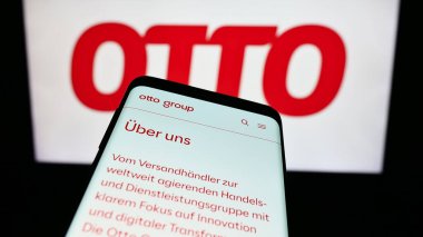 Stuttgart, Germany - 11-14-2023: Smartphone with website of German mail order company Otto GmbH Co KG in front of business logo. Focus on top-left of phone display. clipart