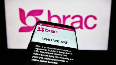 Stuttgart, Germany - 10-06-2023: Smartphone with webpage of international development organization BRAC in front of logo. Focus on top-left of phone display. clipart