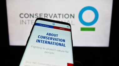 Stuttgart, Almanya - 10-11-2023: Logo önünde Çevre Örgütü Conservation International (CI) web sitesi ile cep telefonu. Telefon ekranının sol üst kısmına odaklan.