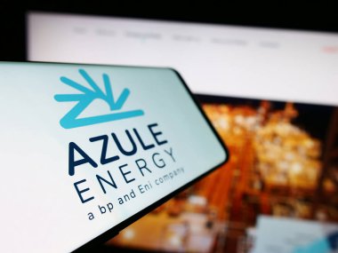 Stuttgart, Germany - 10-28-2023: Mobile phone with logo of Angolan oil company Azule Energy in front of business website. Focus on left of phone display. clipart