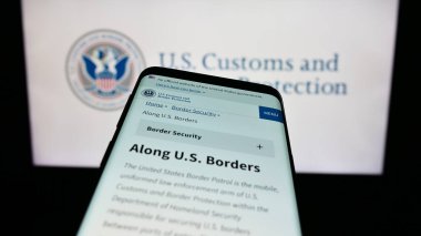 Stuttgart, Almanya - 10-29-2023: Mühür önünde ABD Gümrük ve Sınır Koruma Dairesi (CBP) web sitesi bulunan cep telefonu. Telefon ekranının sol üst kısmına odaklan.