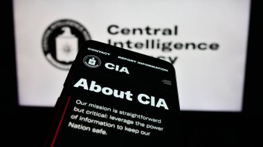 Stuttgart, Germany - 10-29-2023: Smartphone with webpage of US Central Intelligence Agency (CIA) in front of seal. Focus on top-left of phone display. clipart