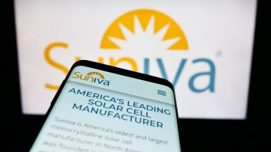 Stuttgart, Germany - 10-30-2023: Smartphone with website of US photovoltaics company Suniva Inc. in front of business logo. Focus on top-left of phone display. clipart