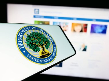 Stuttgart, Almanya - 10-30-2023: İnternet sitesi önünde ABD Eğitim Bakanlığı mührü ile cep telefonu. Telefon ekranının merkez soluna odaklan.