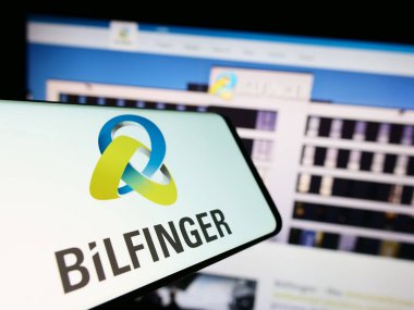 Stuttgart, Germany - 09-14-2023: Mobile phone with logo of German construction company Bilfinger SE on screen in front of website. Focus on center-right of phone display. clipart