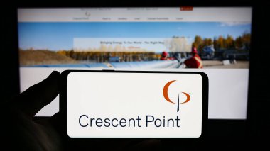 Stuttgart, Almanya - 09-14-2023: Kanadalı petrol şirketi Crescent Point Energy Corp 'un logosunu elinde tutan kişi web sitesinin önünde ekranda. Telefon ekranına odaklan.