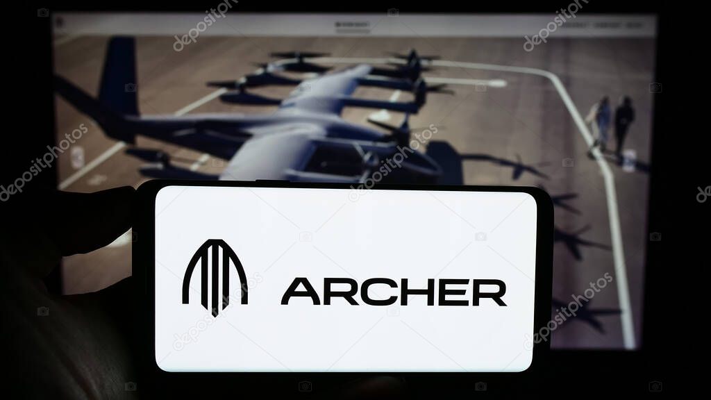Stuttgart, Germany - 09-11-2023: Person holding cellphone with logo of American eVTOL aircraft company Archer Aviation Inc. on screen in front of webpage. Focus on phone display.