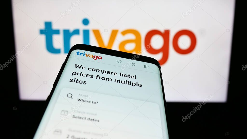 Stuttgart, Germany - 09-14-2023: Mobile phone with website of German hotel metasearch company Trivago N.V. on screen in front of logo. Focus on top-left of phone display.