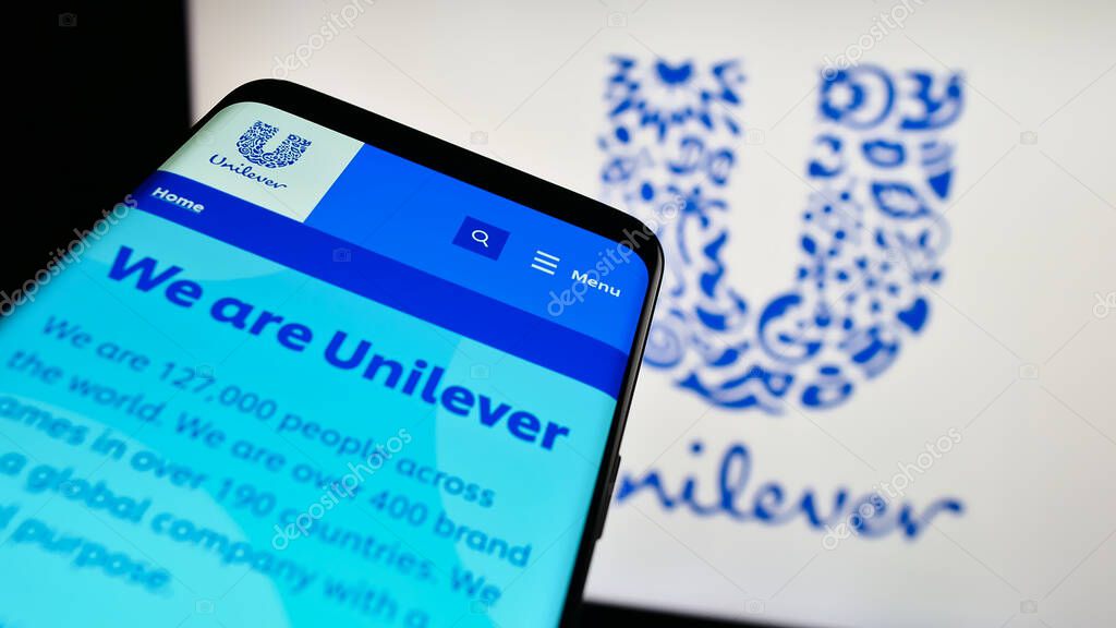 Stuttgart, Germany - 09-19-2023: Mobile phone with website of British consumer goods company Unilever plc on screen in front of business logo. Focus on top-left of phone display.