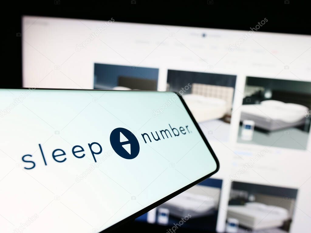 Stuttgart, Germany - 09-20-2023: Cellphone with logo of American bedding company Sleep Number Corporation on screen in front of website. Focus on center of phone display.