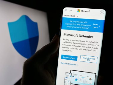 Stuttgart, Almanya - 09-21-2023: Güvenlik yazılımı Microsoft Defender Antivirüs 'ün web sayfası bulunan cep telefonu logolu kişi. Telefon ekranının merkezine odaklan.