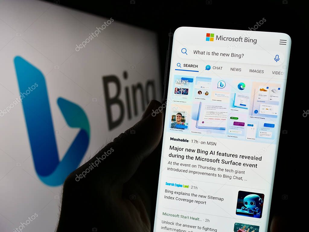 Stuttgart, Germany - 09-22-2023: Person holding cellphone with website of web search engine Microsoft Bing on screen in front of business logo. Focus on center of phone display.