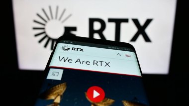 Stuttgart, Germany - 08-06-2023: Smartphone with webpage of US aerospace and defense company RTX Corporation on screen in front of logo. Focus on top-left of phone display. clipart