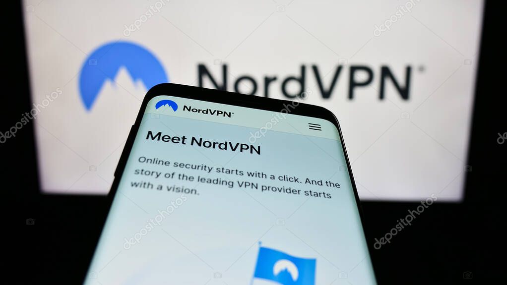 Stuttgart, Germany - 08-17-2023: Mobile phone with website of VPN service NordVPN (Nordsec Ltd.) on screen in front of business logo. Focus on top-left of phone display.