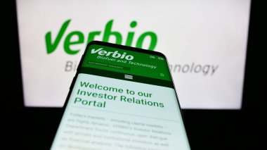 Stuttgart, Germany - 08-21-2023: Mobile phone with webpage of biofuel company Verbio Vereinigte Bioenergie AG on screen in front of logo. Focus on top-left of phone display. clipart