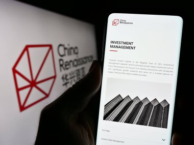 Stuttgart, Almanya - 08-29-2023: Çin Rönesans Holding Şirketi 'nin web sayfası olan akıllı telefon sahibi kişi logonun önünde ekranda görülüyor. Telefon ekranının merkezine odaklan.