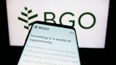 Stuttgart, Almanya - 09-02-2023: Yatırım şirketi BentallGreenOak 'ın (BGO) web siteli akıllı telefon iş logosu önünde ekranda. Telefon ekranının sol üst kısmına odaklan.