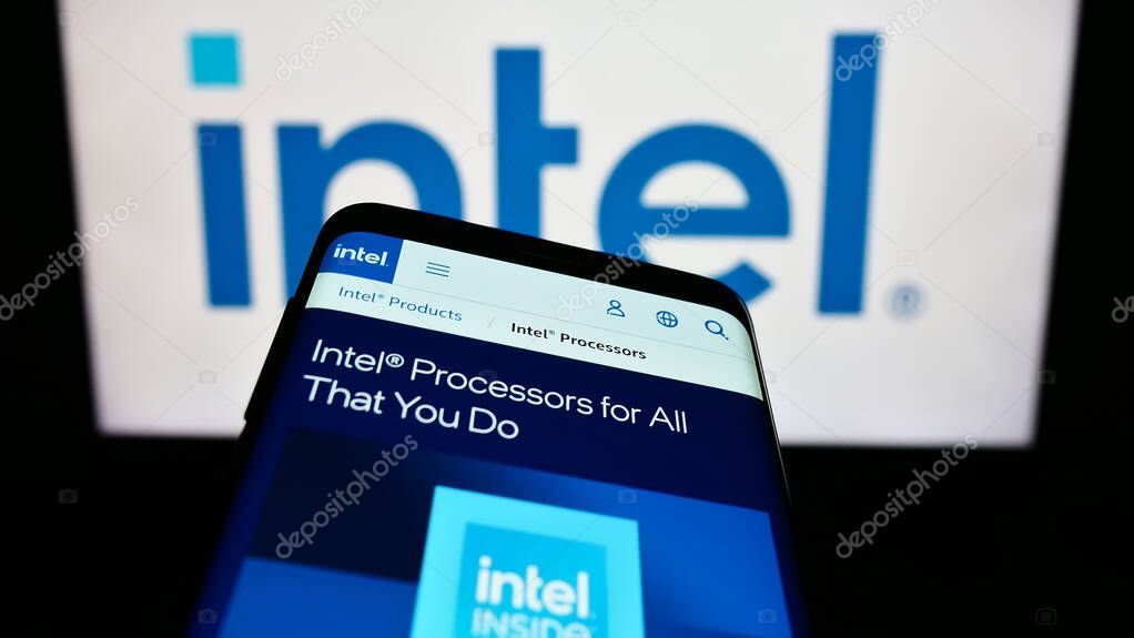 Stuttgart, Germany - 07-29-2023: Smartphone with website of US technology company Intel Corporation on screen in front of business logo. Focus on top-left of phone display.