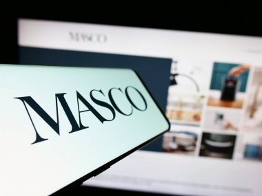 Stuttgart, Germany - 08-04-2023: Cellphone with logo of American home improvement company Masco Corporation on screen in front of website. Focus on left of phone display. clipart