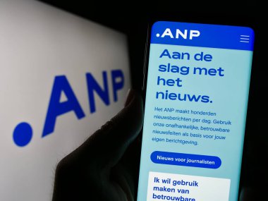 Stuttgart, Almanya - 07-06-2023: Logo önünde ekranda Algemeen Nederlands Persbureau B.V. (ANP) web sitesi bulunan kişi. Telefon ekranının merkezine odaklan.