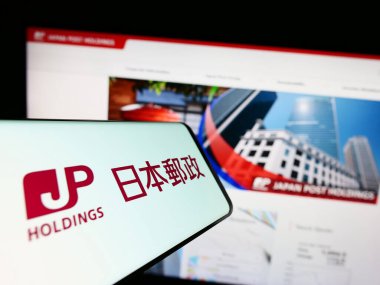 Stuttgart, Almanya - 07-04-2023: Japon şirketi Japan Post Holding Co. Ltd. nin logolu akıllı telefon web sitesinin önünde ekranda. Telefon ekranının merkez sağına odaklan.