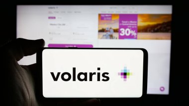 Stuttgart, Almanya - 11-11-2024: Meksikalıların düşük maliyetli havayolu şirketi Volaris 'in logosunun bulunduğu cep telefonu sahibi kişi iş sayfasının önünde ekranda. Telefon ekranına odaklan.