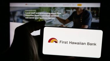 Stuttgart, Almanya - 11-11-2024: ABD 'li finans şirketi First Hawaiian Inc.' in logosunun bulunduğu cep telefonu web sayfasının önünde ekranda. Telefon ekranına odaklan.