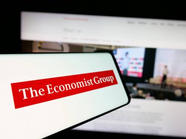 Stuttgart, Germany - 11-26-2024: Mobile phone with logo of British media company The Economist Group on screen in front of website. Focus on center-left of phone display. clipart