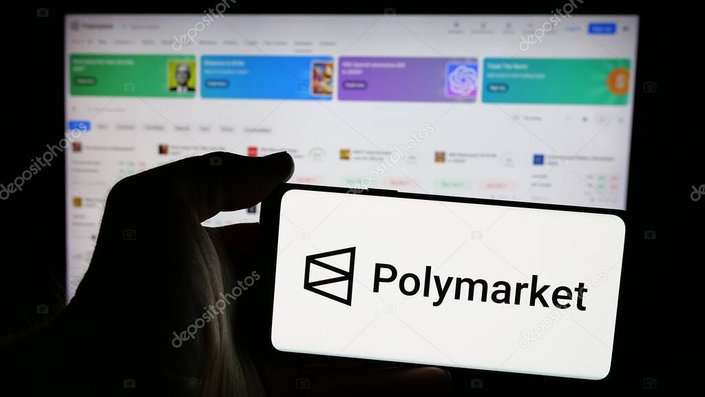 Stuttgart, Germany - 11-27-2024: Person holding mobile phone with logo of crypto prediction market company Polymarket on screen in front of web page. Focus on phone display.