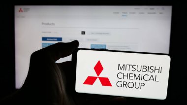 Stuttgart, Almanya - 12-05-2024: İnternet sayfasının önünde ekranda Mitsubishi Kimya Grubu Şirketi 'nin logosunun bulunduğu cep telefonu sahibi kişi. Telefon ekranına odaklan.