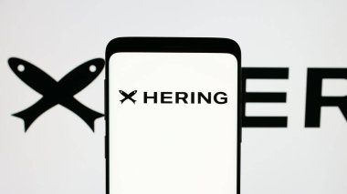 Stuttgart, Germany - 12-18-2024: Mobile phone with logo of Brazilian fashion company Hering on screen. Focus on phone display. clipart