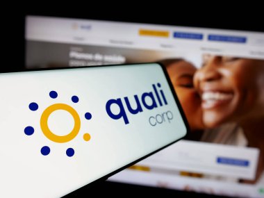 Stuttgart, Germany - 12-19-2024: Cellphone with logo of Brazilian health insurance company Qualicorp SA on screen in front of website. Focus on center-left of phone display. clipart