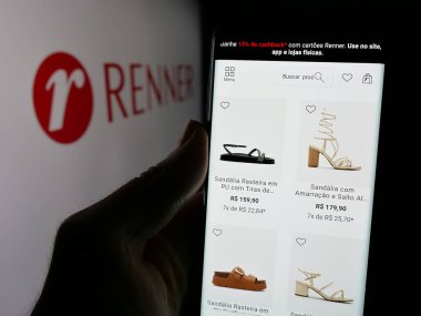 Stuttgart, Almanya - 12-19-2024: Brezilyalı perakende firması Renner 'ın internet sayfası ile cep telefonu tutan kişi logonun önünde ekranda. Telefon ekranının merkezine odaklan.
