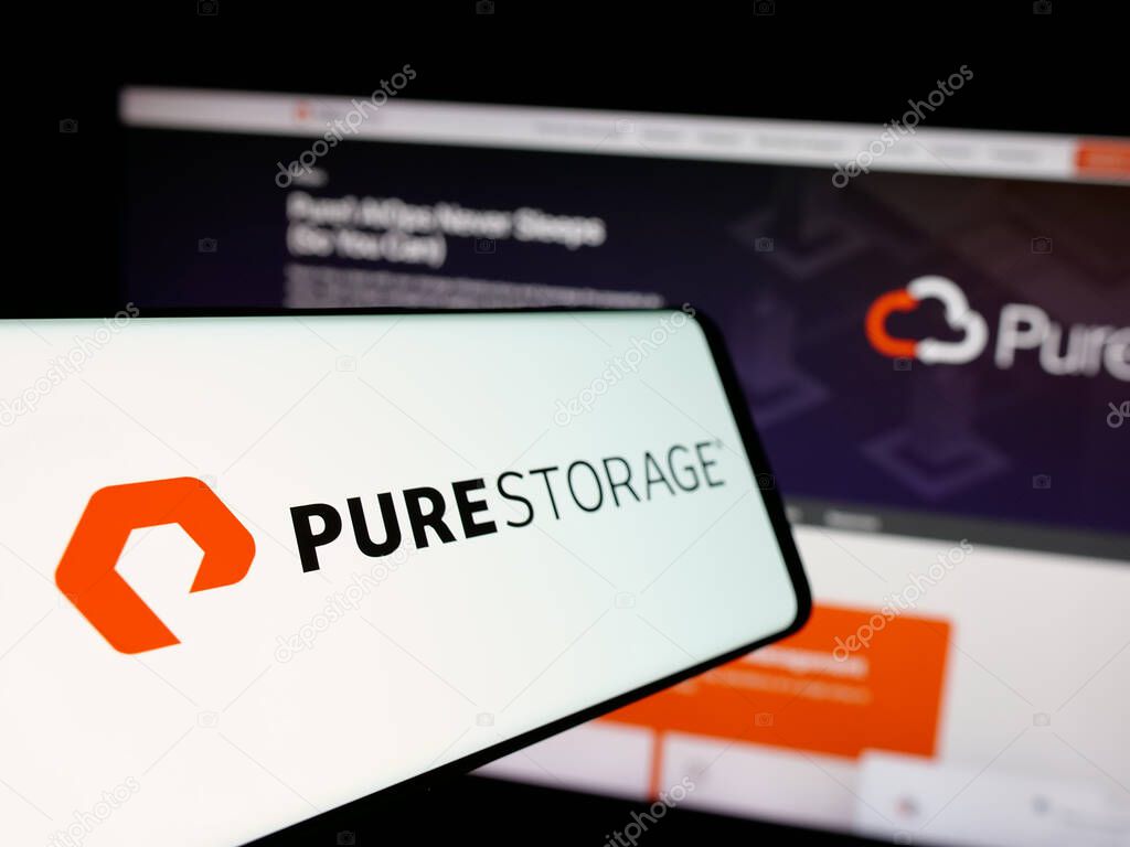 Stuttgart, Germany - 12-13-2024: Mobile phone with logo of American software company Pure Storage Inc. on screen in front of website. Focus on center-left of phone display.
