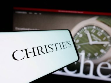 Stuttgart, Germany - 01-02-2024: Mobile phone with logo of British auctioneer company Christie's on screen in front of business website. Focus on center-left of phone display. clipart