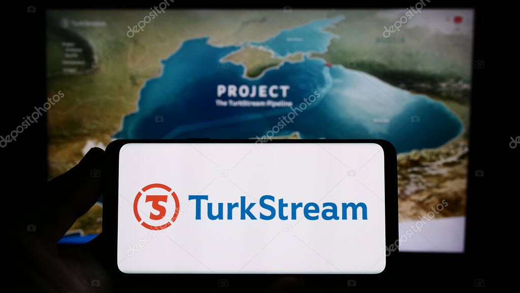 Stuttgart, Germany - 07-18-2023: Person holding smartphone with logo of natural gas pipeline TurkStream on screen in front of website. Focus on phone display.