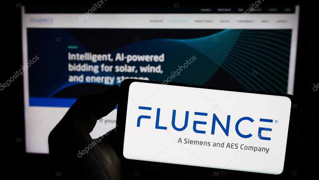 Stuttgart, Germany - 06-18-2023: Person holding cellphone with logo of US company Fluence Energy LLC on screen in front of business webpage. Focus on phone display.