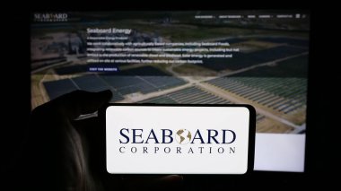 Stuttgart, Almanya - 01-07-2024: ABD 'li Seaboard Corporation şirketinin logosuyla cep telefonu sahibi kişi iş sayfasının önünde ekranda. Telefon ekranına odaklan.