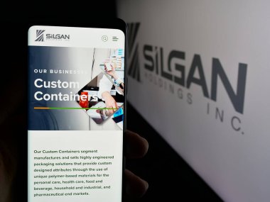 Stuttgart, Almanya - 01-08-2024: ABD 'li ambalaj şirketi Silgan Holding Inc.' in web sayfası ile akıllı telefon sahibi kişi logonun önünde ekranda. Telefon ekranının merkezine odaklan.